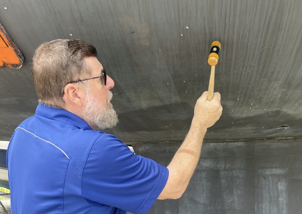 A man holding a wooden stick in his hand.